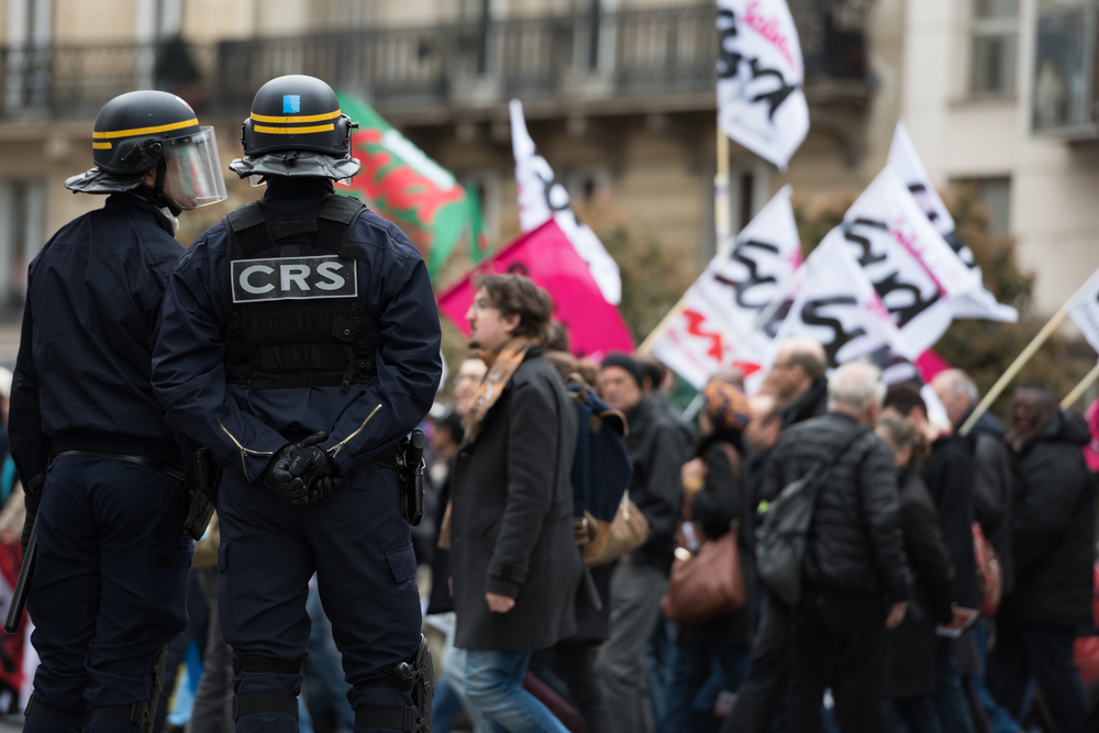 French police, anti-riot squad,surrounded by fire during the massive protest over the labor law reforms.